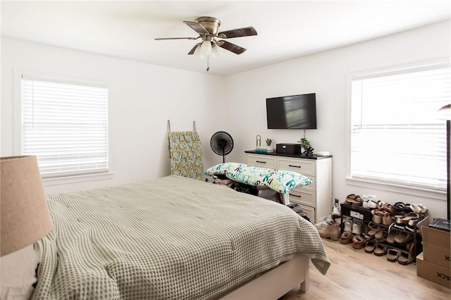 300 Community Dr, Waycross, GA 31501 - bedroom featuring light wood-style floors, multiple windows, and a ceiling fan