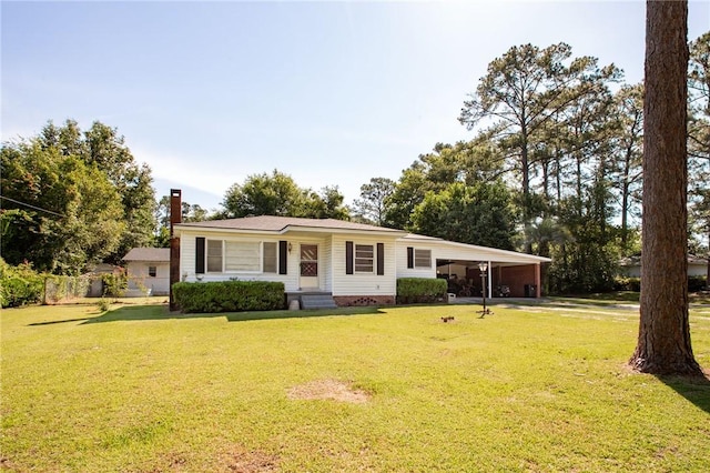 300 Community Dr, Waycross, GA 31501 - ranch-style home featuring a front lawn, a chimney, and an attached carport