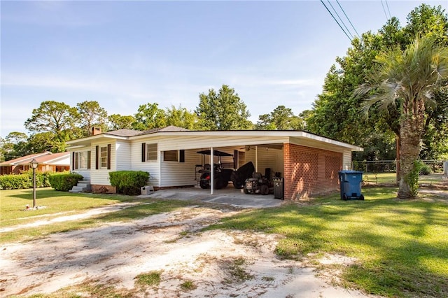 300 Community Dr, Waycross, GA 31501 - view of front of house featuring dirt driveway, brick siding, a carport, and a chimney