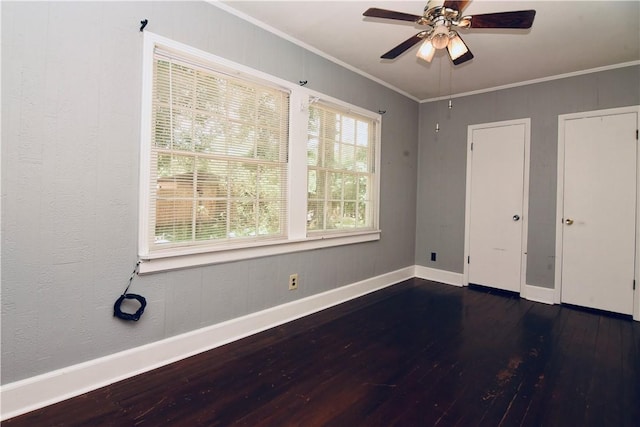 2108 Darling Ave, Waycross, GA 31501 - unfurnished bedroom with wood finished floors, baseboards, crown molding, two closets, and a ceiling fan