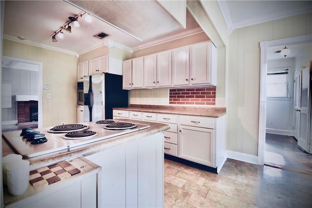 2108 Darling Ave, Waycross, GA 31501 - kitchen with stainless steel refrigerator with ice dispenser, white electric stovetop, ornamental molding, white cabinets, and track lighting