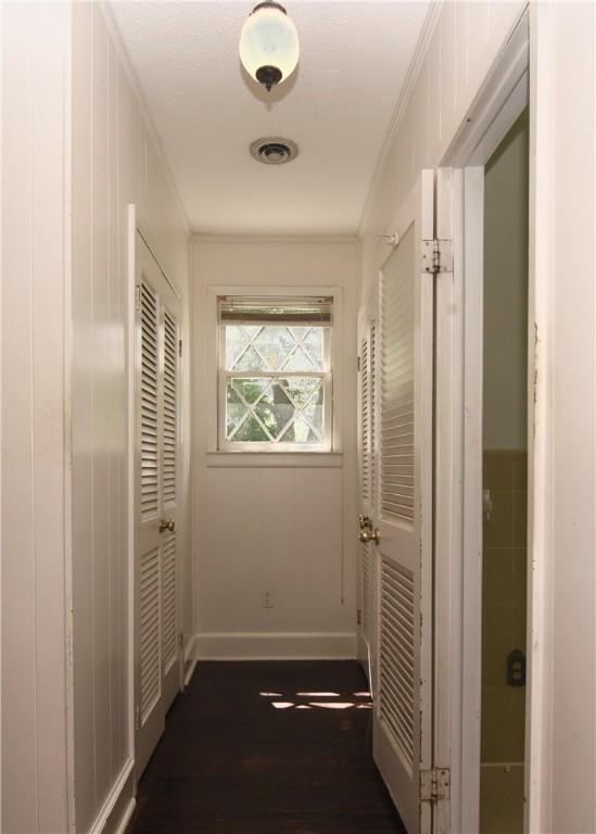 2108 Darling Ave, Waycross, GA 31501 - hallway featuring dark wood-style flooring, crown molding, and baseboards