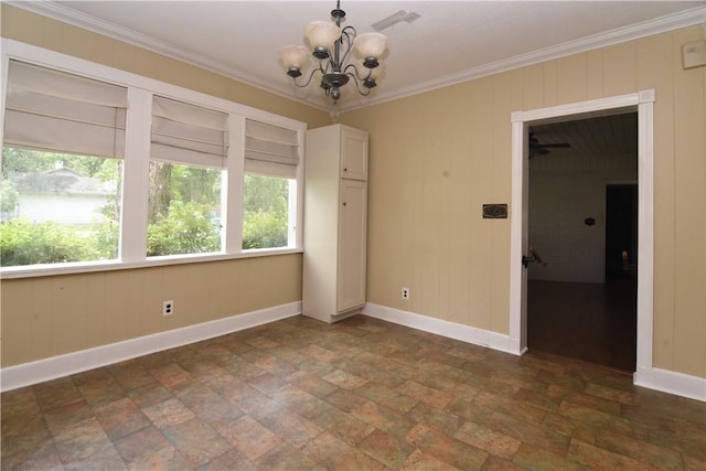 2108 Darling Ave, Waycross, GA 31501 - empty room with a chandelier, stone finish floors, baseboards, ornamental molding, and wooden walls