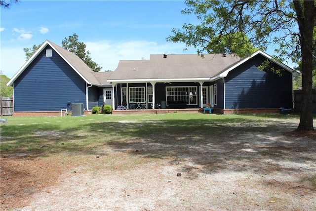 back of house featuring central air condition unit and a yard