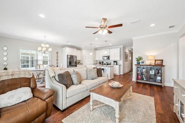 139 Allie Loop, Brunswick, GA 31525 - living room with crown molding, a ceiling fan, a chandelier, recessed lighting, and dark wood-type flooring