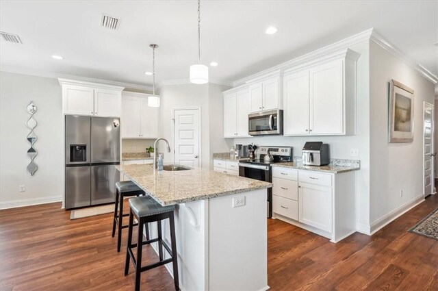 139 Allie Loop, Brunswick, GA 31525 - kitchen featuring appliances with stainless steel finishes, ornamental molding, dark wood finished floors, white cabinetry, and recessed lighting