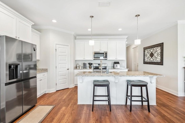 139 Allie Loop, Brunswick, GA 31525 - kitchen featuring stainless steel appliances, white cabinets, dark wood-type flooring, ornamental molding, and hanging light fixtures