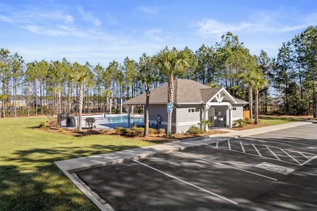 139 Allie Loop, Brunswick, GA 31525 - uncovered parking lot featuring an outdoor pool