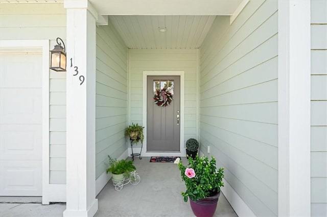 139 Allie Loop, Brunswick, GA 31525 - view of exterior entry with a porch and an attached garage
