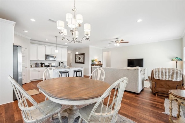 139 Allie Loop, Brunswick, GA 31525 - dining room with crown molding, recessed lighting, dark wood-type flooring, a ceiling fan, and a chandelier