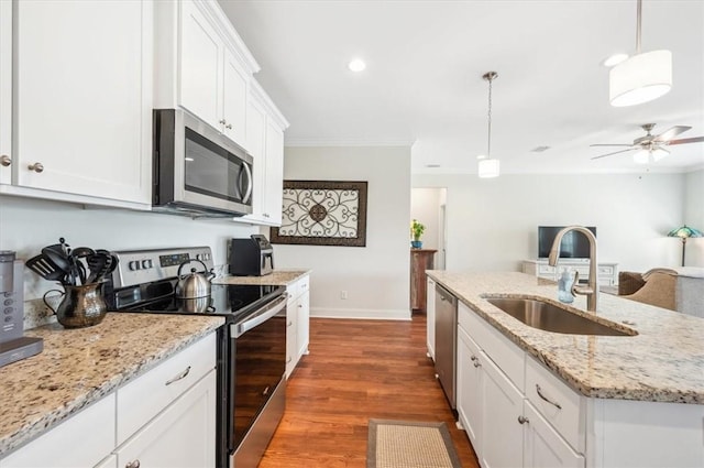 139 Allie Loop, Brunswick, GA 31525 - kitchen featuring stainless steel appliances, ceiling fan, ornamental molding, dark wood-style flooring, and white cabinetry