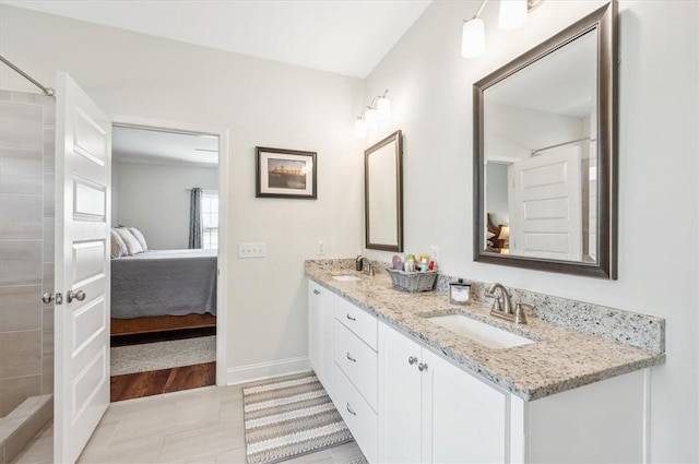 139 Allie Loop, Brunswick, GA 31525 - ensuite bathroom featuring double vanity, tiled shower, and tile patterned flooring