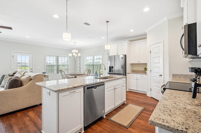 139 Allie Loop, Brunswick, GA 31525 - kitchen with stainless steel appliances, open floor plan, crown molding, white cabinetry, and dark wood-type flooring