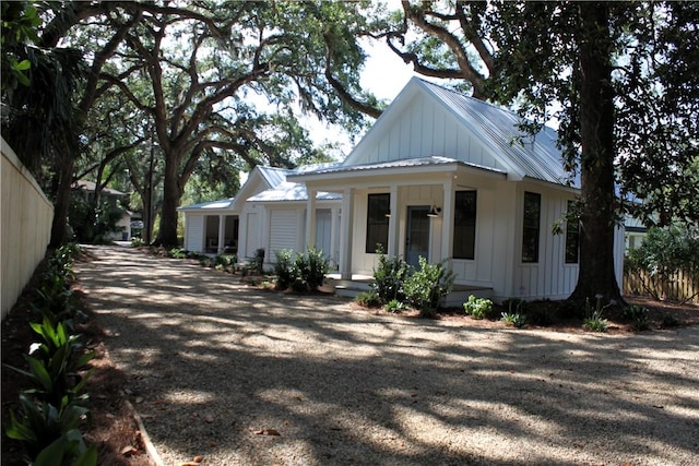247 Circle Dr, Saint Simons Island, GA 31522 - view of side of home featuring board and batten siding and metal roof