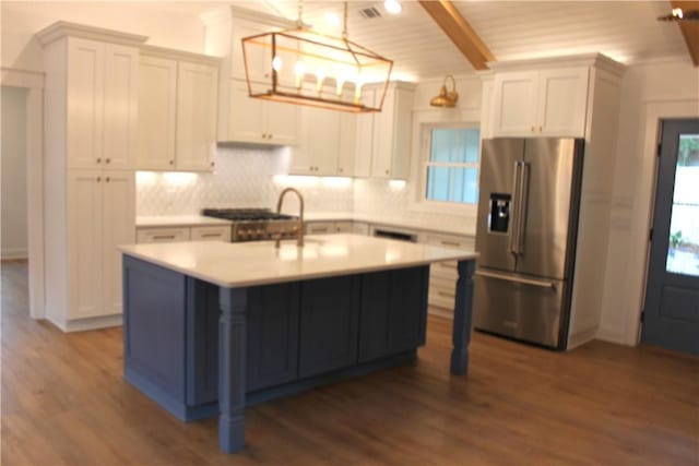 247 Circle Dr, Saint Simons Island, GA 31522 - kitchen featuring high quality fridge, backsplash, dark wood finished floors, light countertops, and beamed ceiling