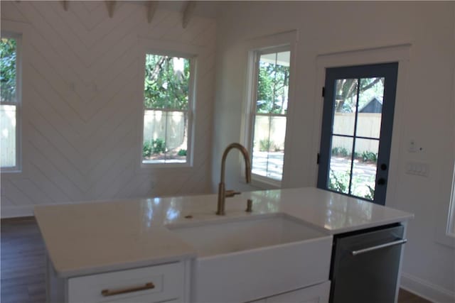 247 Circle Dr, Saint Simons Island, GA 31522 - kitchen with dishwashing machine, a sink, healthy amount of natural light, and white cabinetry