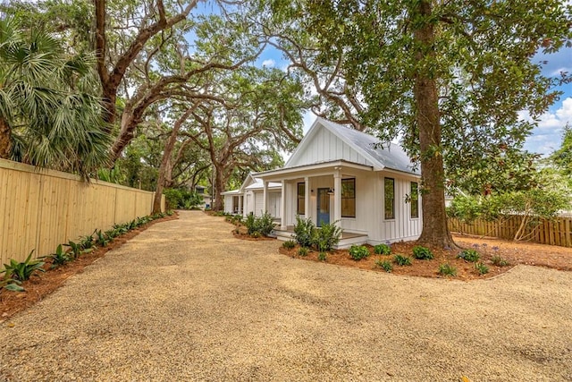 247 Circle Dr, Saint Simons Island, GA 31522 - view of side of home featuring covered porch and driveway