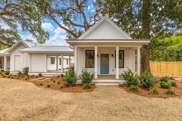 247 Circle Dr, Saint Simons Island, GA 31522 - modern inspired farmhouse featuring board and batten siding, covered porch, and metal roof