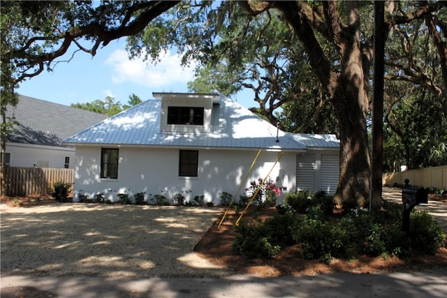 247 Circle Dr, Saint Simons Island, GA 31522 - view of front of home with metal roof and stucco siding