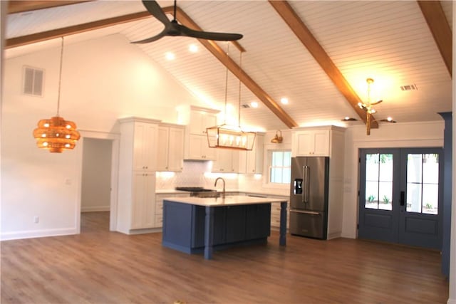 247 Circle Dr, Saint Simons Island, GA 31522 - kitchen with high end fridge, beam ceiling, a chandelier, light countertops, and french doors
