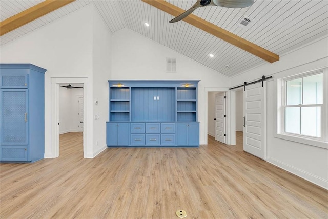 247 Circle Dr, Saint Simons Island, GA 31522 - unfurnished living room featuring ceiling fan, high vaulted ceiling, a barn door, light wood-style floors, and baseboards