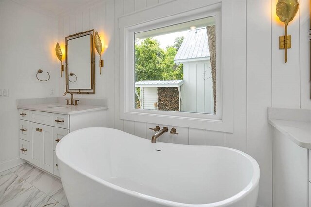 247 Circle Dr, Saint Simons Island, GA 31522 - full bathroom with a soaking tub, marble finish floors, and vanity