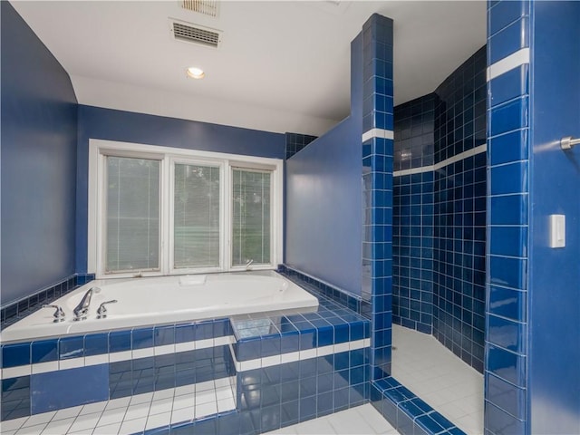 bathroom featuring tile patterned floors and independent shower and bath