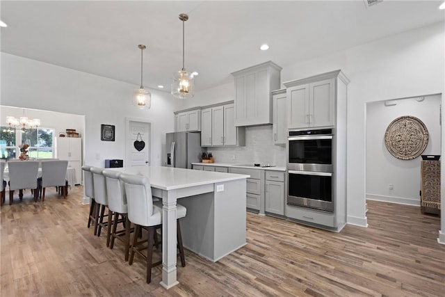 1317 Kyles Loop NE, Townsend, GA 31331 - kitchen featuring appliances with stainless steel finishes, gray cabinetry, a chandelier, light countertops, and recessed lighting