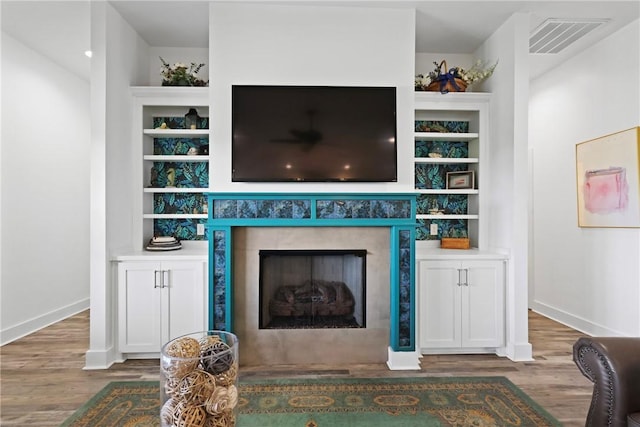 1317 Kyles Loop NE, Townsend, GA 31331 - living area featuring wood finished floors, a fireplace, and built in shelves