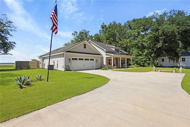1317 Kyles Loop NE, Townsend, GA 31331 - view of front of property featuring concrete driveway, a front yard, a garage, and board and batten siding