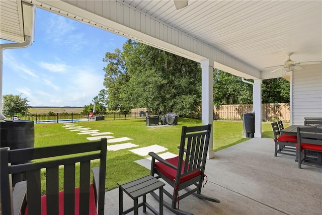 1317 Kyles Loop NE, Townsend, GA 31331 - fenced backyard with ceiling fan, a pool, a patio area, and outdoor dining space