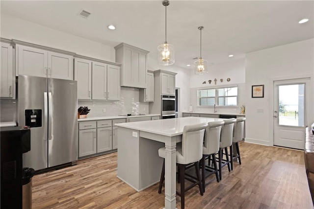 1317 Kyles Loop NE, Townsend, GA 31331 - kitchen with stainless steel appliances, gray cabinetry, recessed lighting, light countertops, and tasteful backsplash