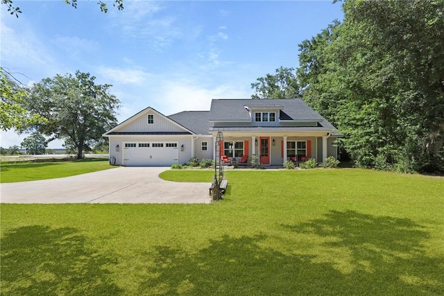 1317 Kyles Loop NE, Townsend, GA 31331 - view of front of house featuring covered porch, concrete driveway, a garage, a front lawn, and board and batten siding