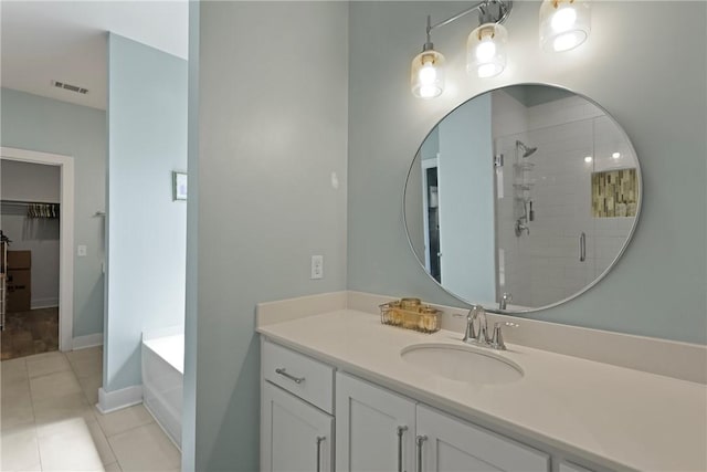 1317 Kyles Loop NE, Townsend, GA 31331 - bathroom with vanity, a shower stall, a bath, tile patterned floors, and a walk in closet