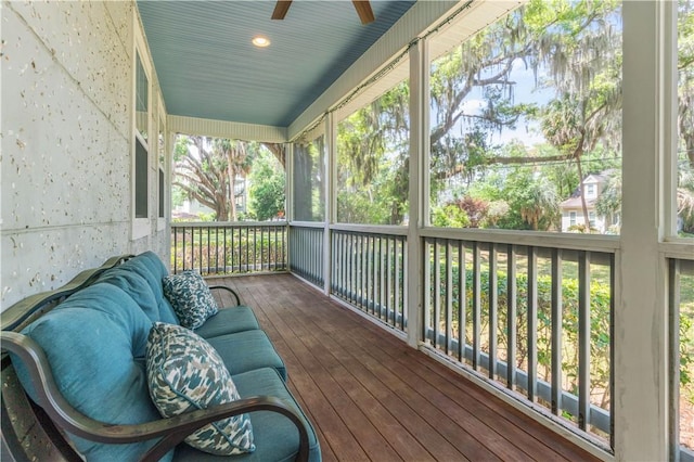 sunroom / solarium featuring ceiling fan