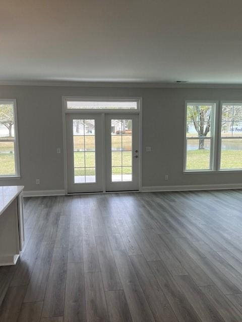 empty room featuring crown molding and dark wood-type flooring