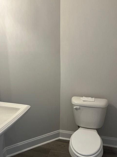 bathroom featuring hardwood / wood-style flooring and toilet