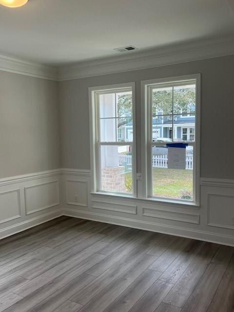 spare room featuring crown molding and hardwood / wood-style floors