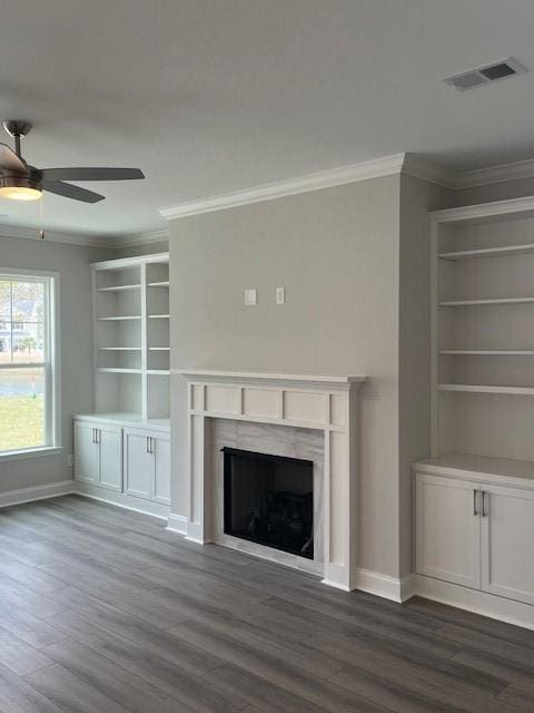 unfurnished living room with crown molding, dark hardwood / wood-style flooring, and ceiling fan