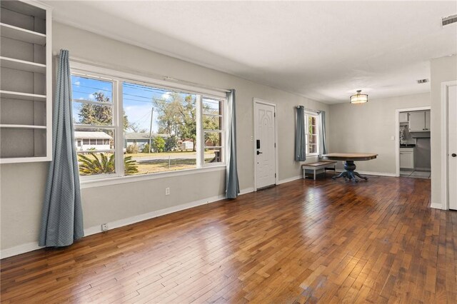 interior space featuring a healthy amount of sunlight, visible vents, baseboards, and hardwood / wood-style floors