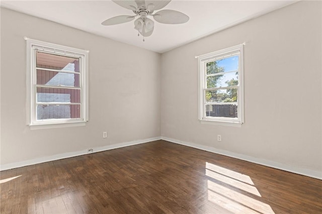 empty room featuring ceiling fan, baseboards, and wood finished floors