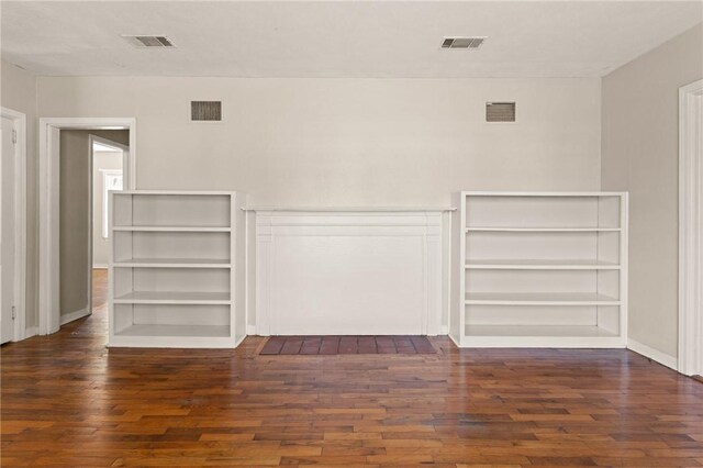 unfurnished room featuring visible vents and wood finished floors