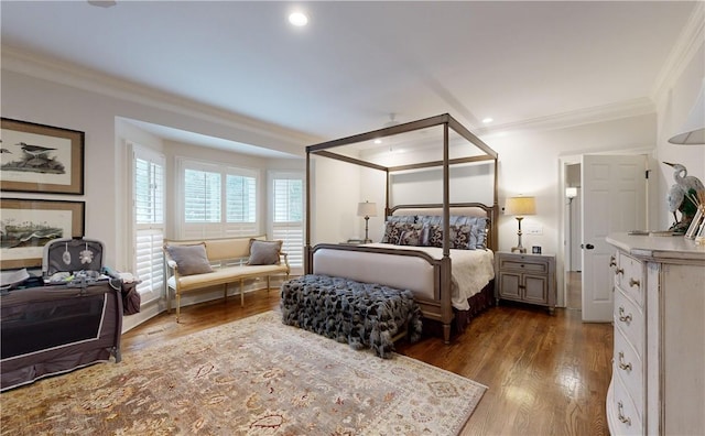 bedroom with hardwood / wood-style flooring and ornamental molding