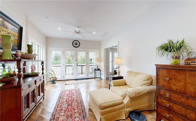 interior space with light hardwood / wood-style floors, french doors, and ceiling fan