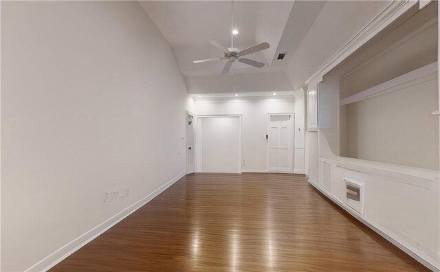 spare room featuring vaulted ceiling, dark hardwood / wood-style floors, and ceiling fan