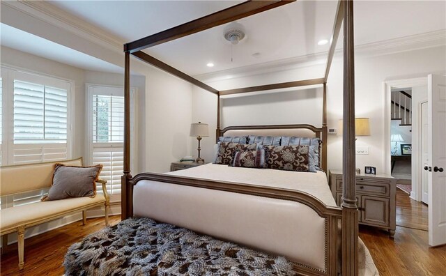 bedroom featuring ceiling fan, ornamental molding, and hardwood / wood-style floors