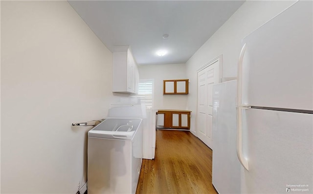washroom featuring light hardwood / wood-style flooring and washer and dryer
