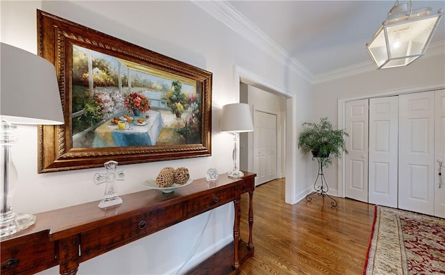entrance foyer featuring crown molding and wood-type flooring
