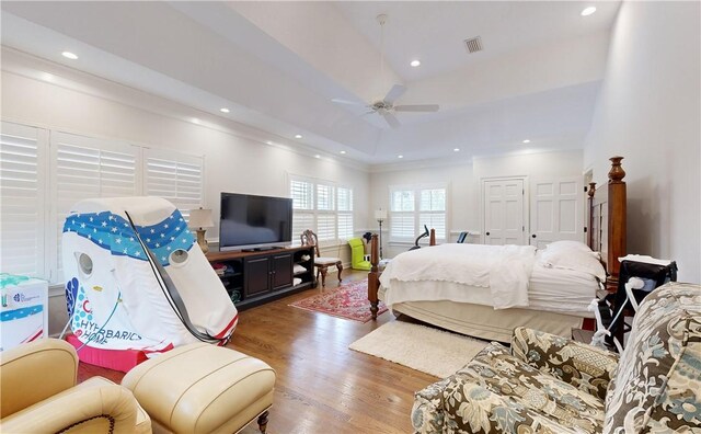 bedroom featuring crown molding, ceiling fan, and dark hardwood / wood-style flooring