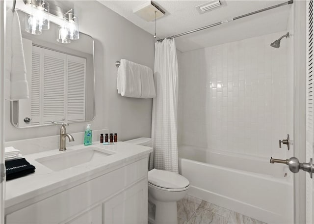 full bathroom with vanity, shower / bath combination with curtain, a textured ceiling, and toilet